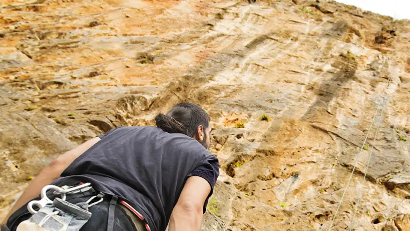 person climbing a mountain