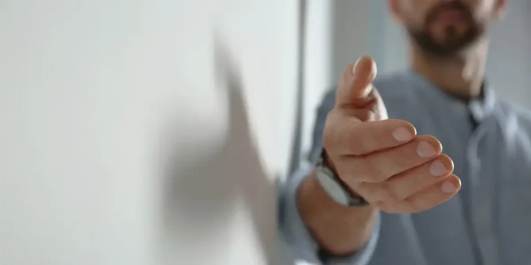 man reaching out his hand