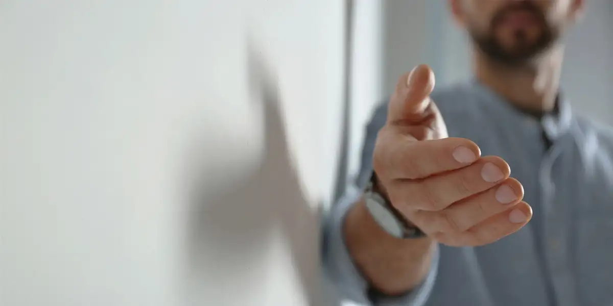 Man reaching out his hand towards the camera