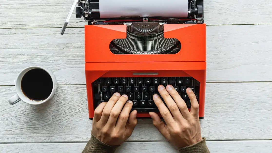 person typing on a typewriter