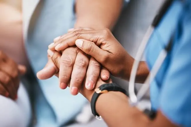 Doctor comforting a patient