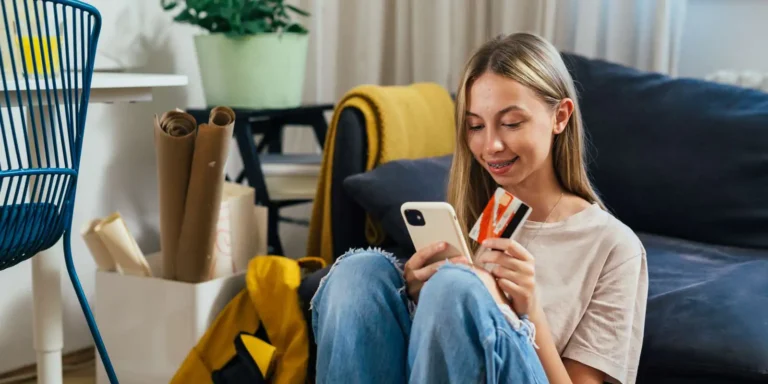 girl holding a credit card making a mobile purchase