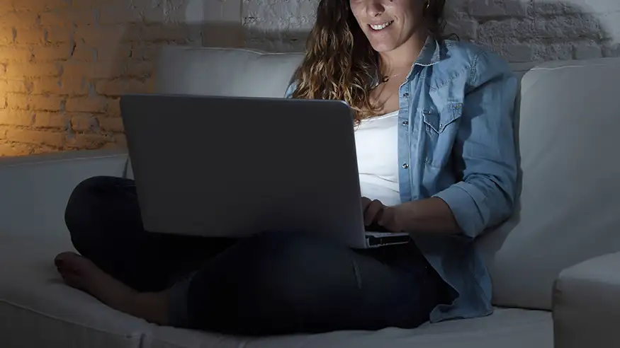 girl using her laptop on couch
