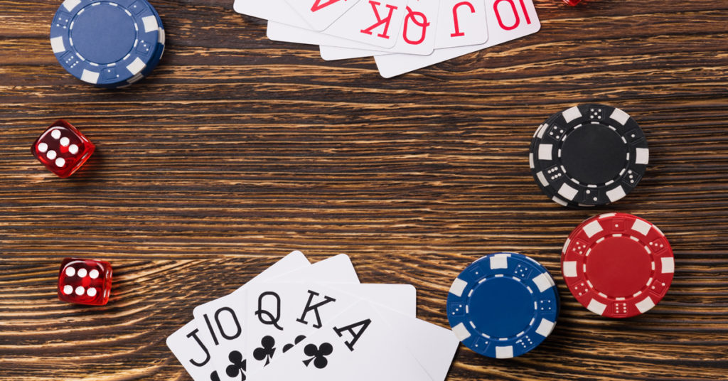 playing cards, poker chips, and dice on a table