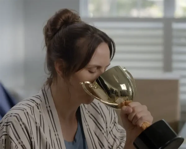 woman drinking from trophy