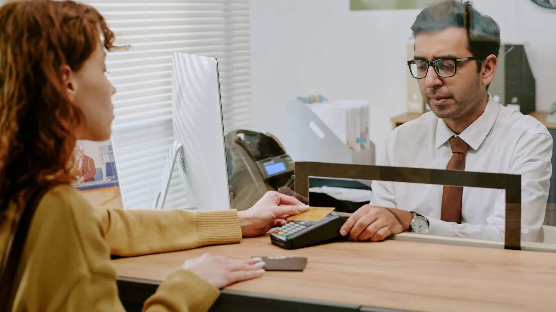woman paying cashier using a credit card